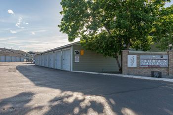 An empty parking lot next to a row of garages